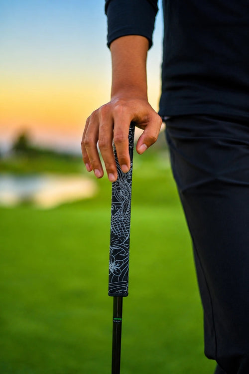 Kaiyen Jewel black and silver koi-engraved putter grip held on the course at golden hour